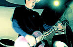Ted playing guitar; circa 2001 © Ted Chau